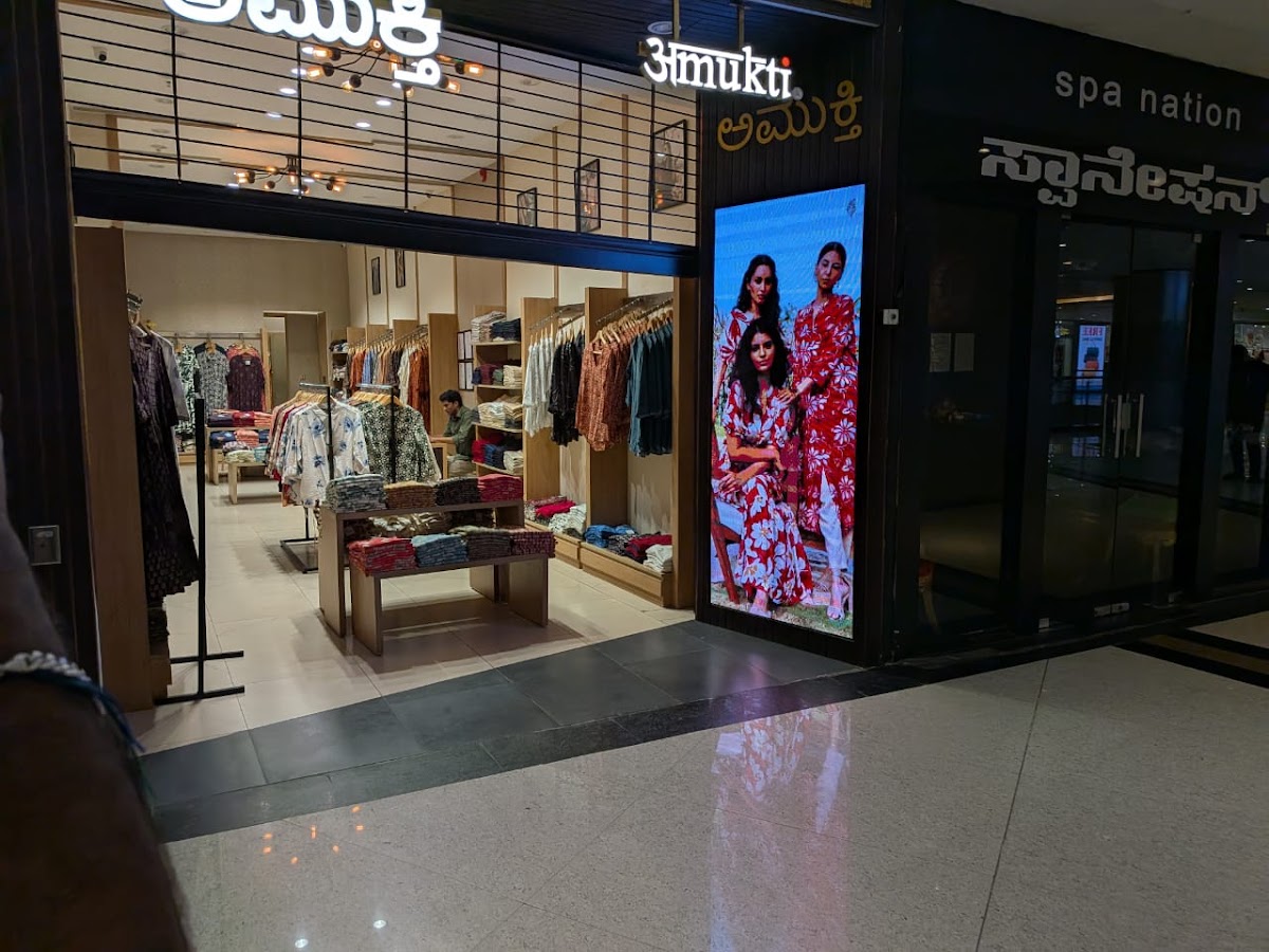 LED video wall display in a retail store showing 3 women in fashion